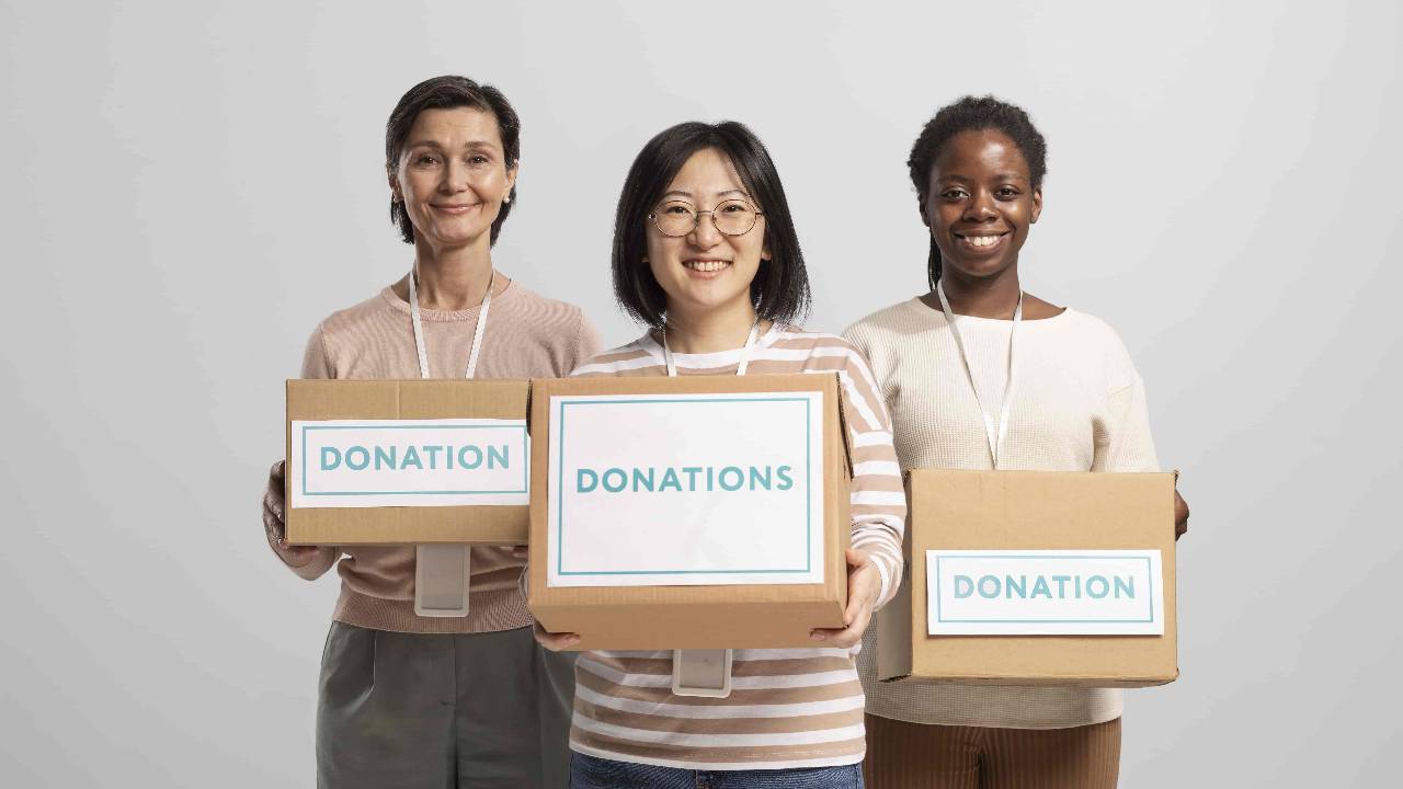 Volunteers holding boxes containing donations charity